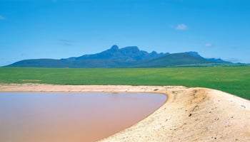 Farm dam in the south-west of WA with green fields and Stirling Ranges in the background