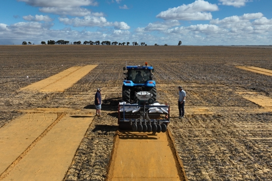 Two men and a tractor in a paddock