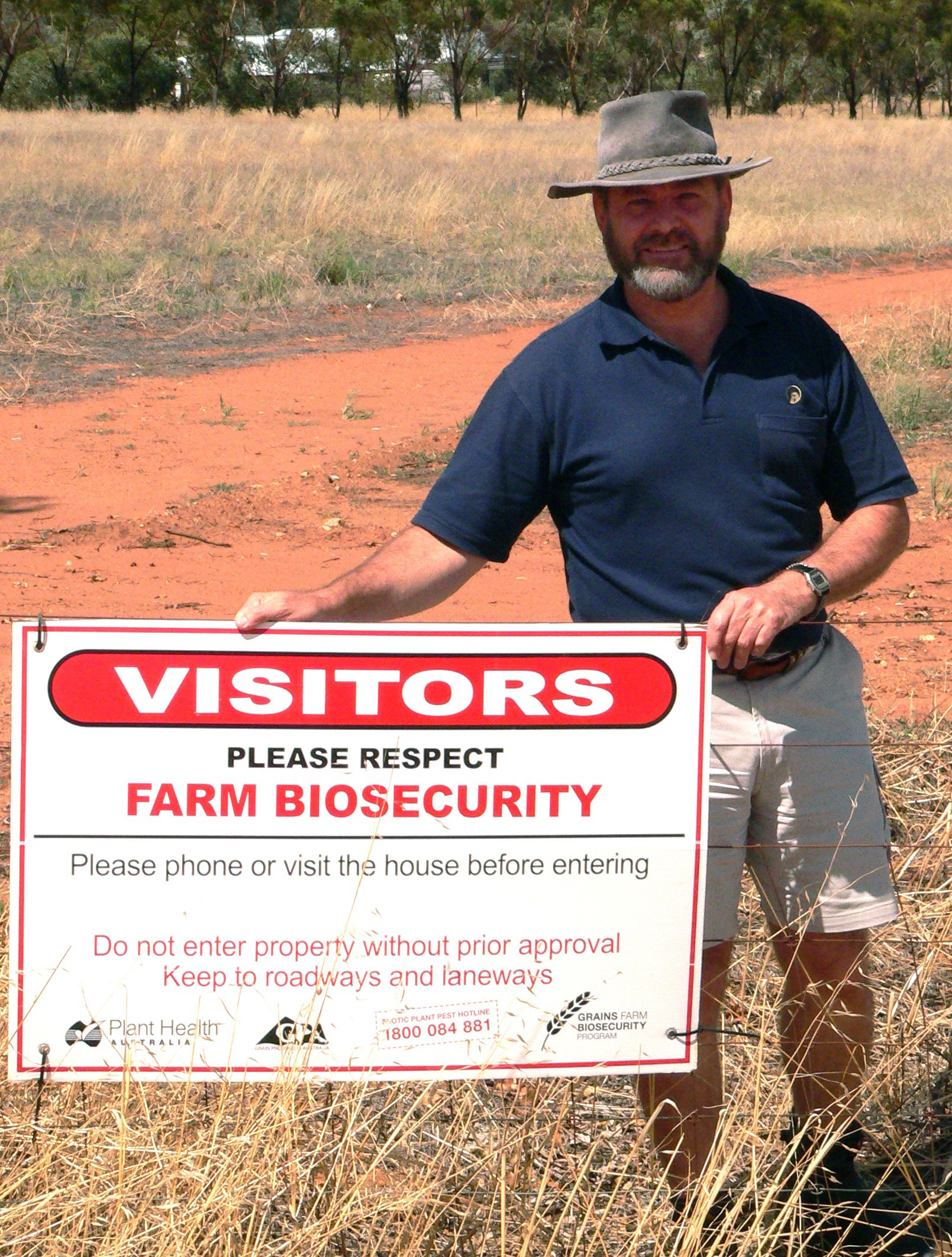 Man beside biosecurity sign