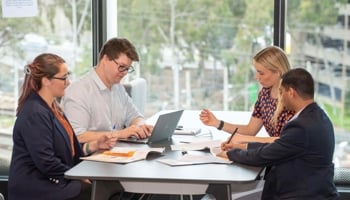 People at a table having a meeting