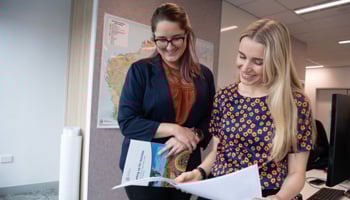 Two people reviewing documents