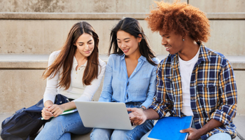 Group of students looking at laptop