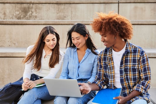 Group of students looking at laptop