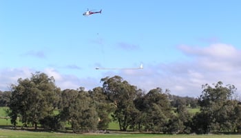 Flying aeroplane dangling a pentagon
