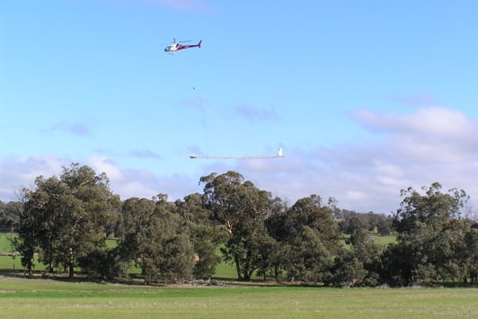 Flying aeroplane dangling a pentagon